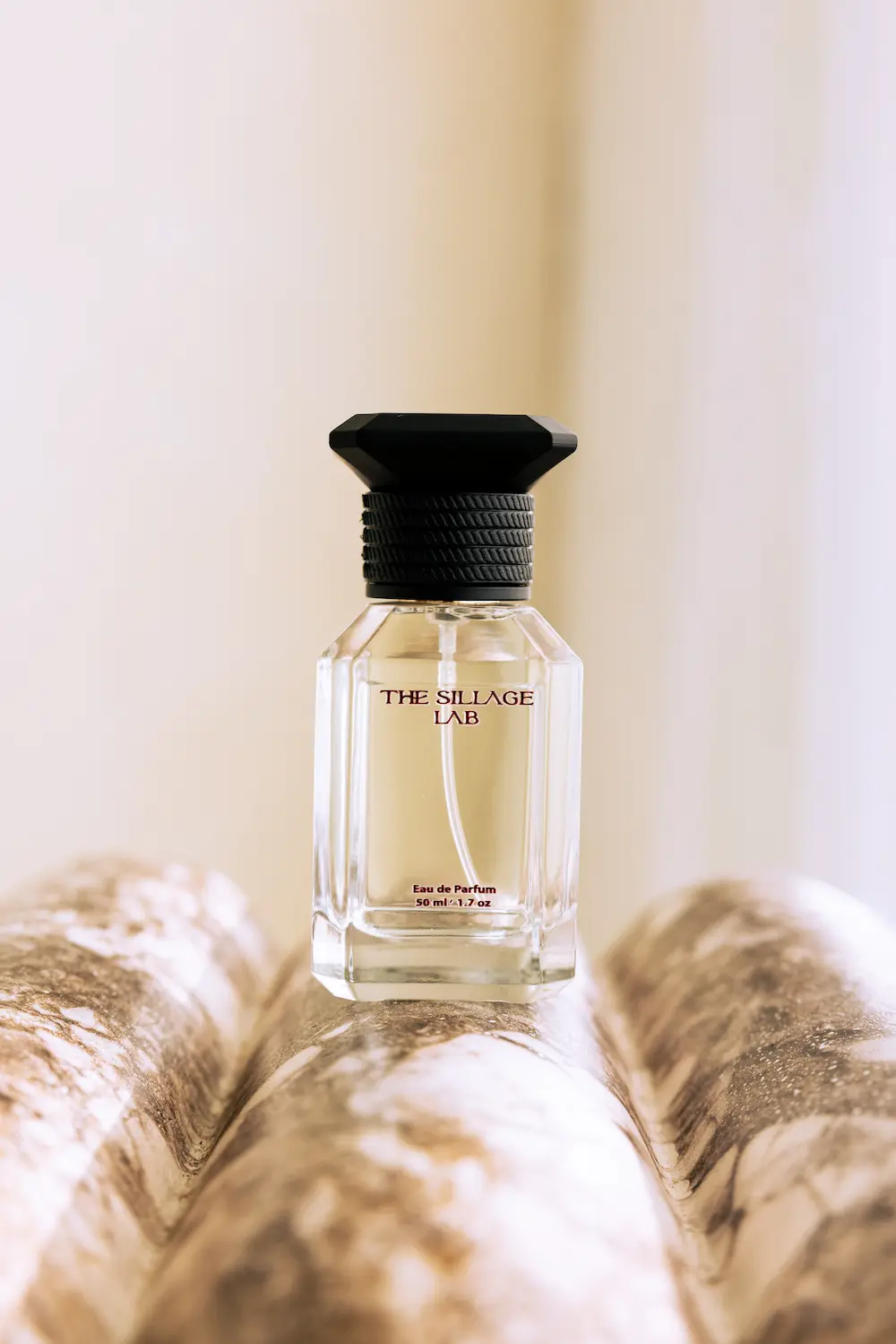 The Sillage Lab perfume bottle on feathers